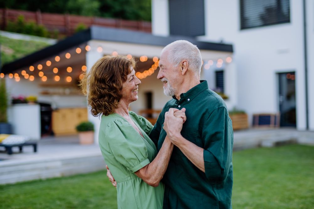 Senior couple dancing at their backyard 