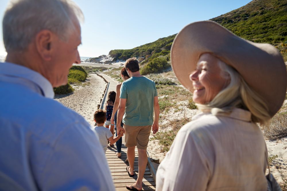Senior couple looking at each other while walking on a beach